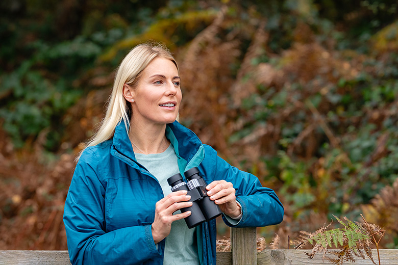 RSPB Buzzard binoculars held by blonde woman