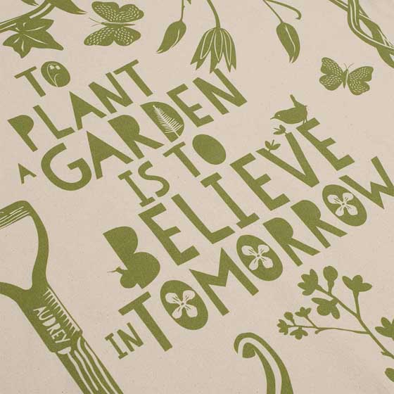 'To plant a garden' quote apron product photo back L